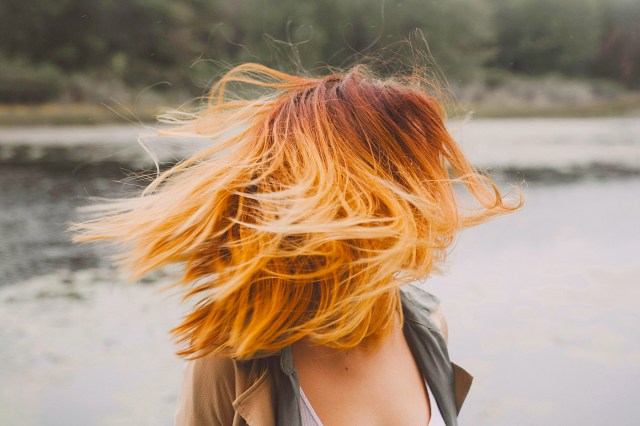 woman with orange hair shaking her head