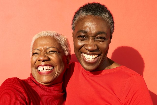 two black women with salt and pepper hair and red shirts