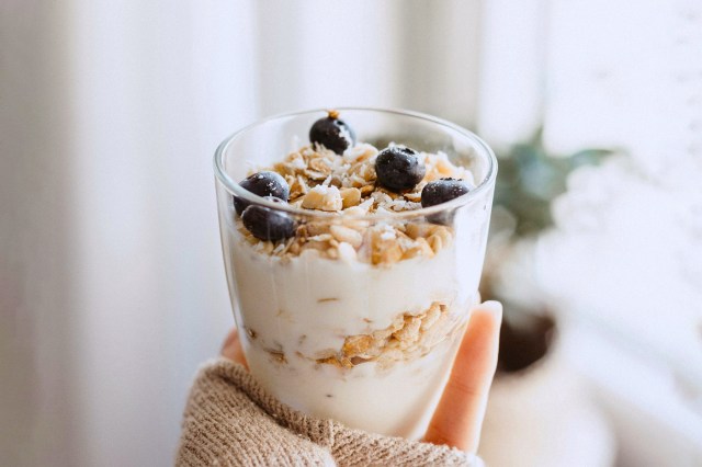 clear cup of granola, yogurt and blueberries 