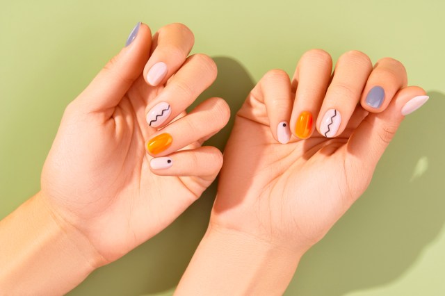 white hands with mixed nail art 