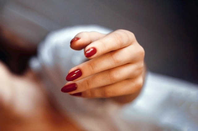 woman's hand with red nails