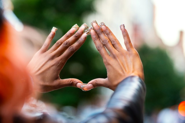 black hands with decorated flared nails 