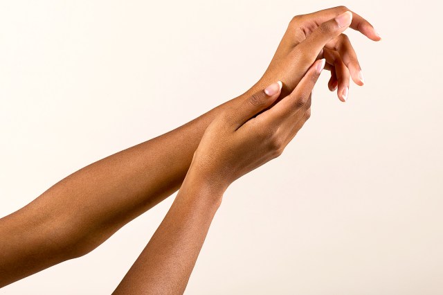 Gentle black female hands with natural manicure
