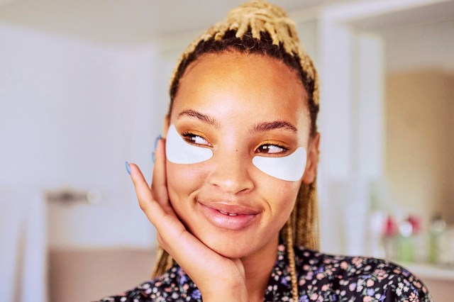 Shot of a woman wearing under-eye gel patches as part of her beauty regime