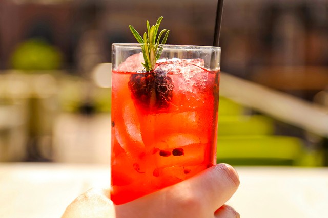 person holding glass of drink, A Cocktail on the Patio