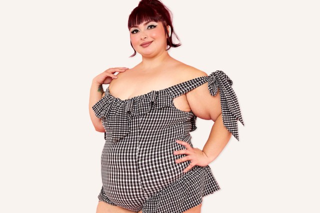 A plus sized woman wearing a one piece bathing suit