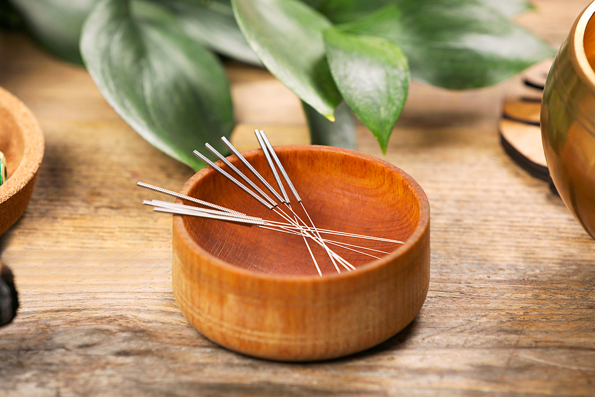 wood dish of acupuncture needles