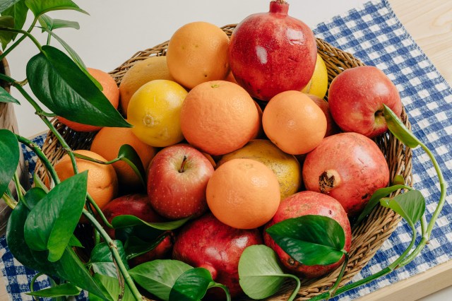 a basket filled with lots of fruit on top of a table