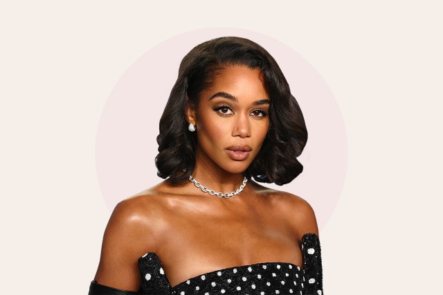 Photo of Laura Harrier in polka dot dress, bob haircut, in front of pink circle