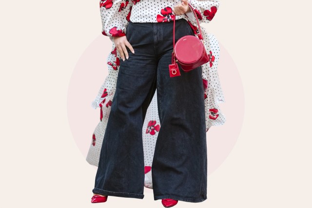 guest wears sunglasses, a white and black and red off-shoulder gathered top with red floral print , black wide leg denim flared pants , a red leather circular Jacquemus bag, pointed shoes