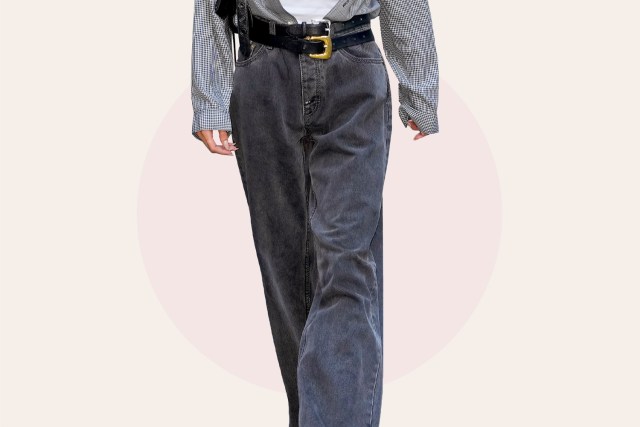 a woman wearing dark gray jeans