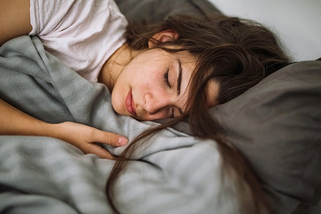 Young woman sleeping in bedroom