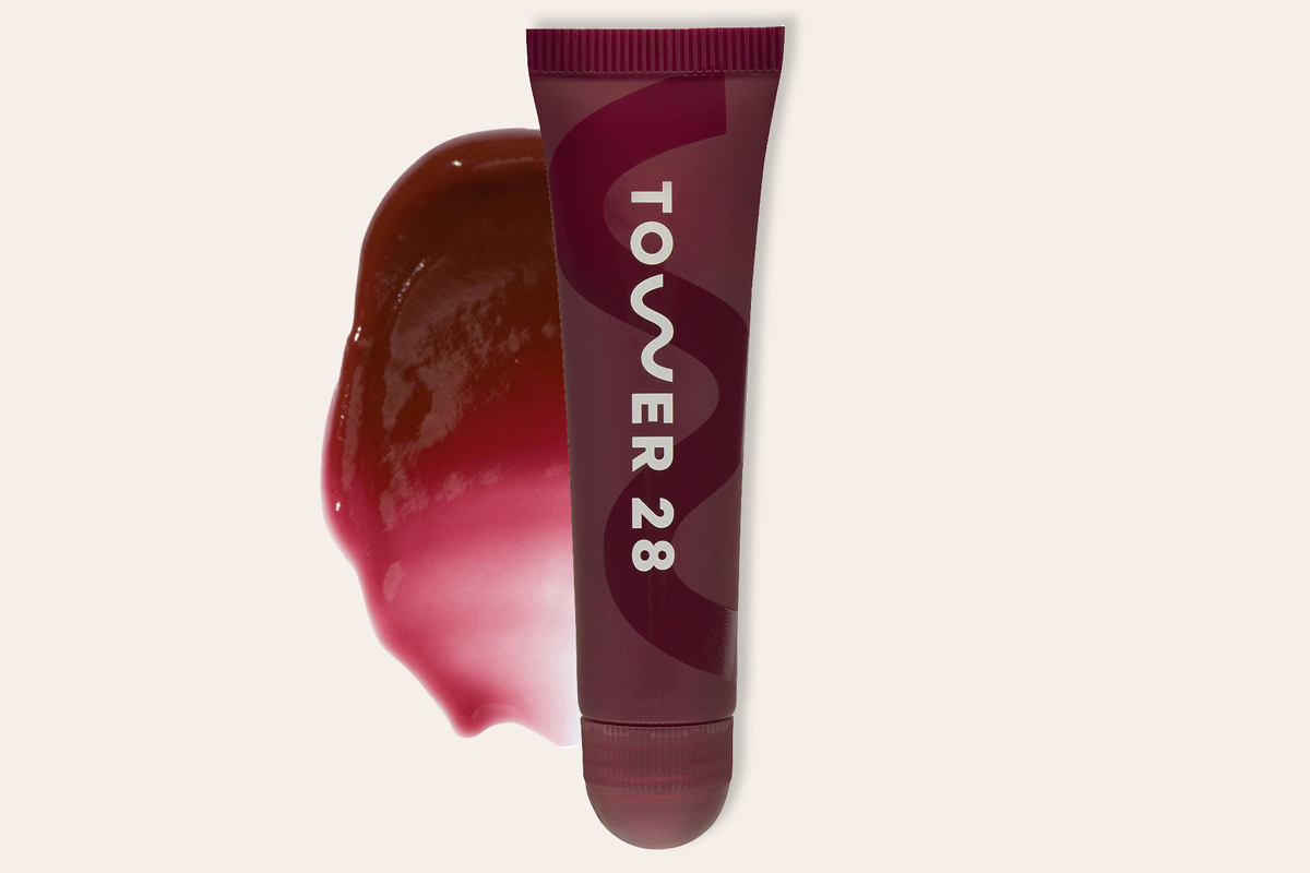 A tube of Tower28 Lip Softie Lip Treatment in a deep purple-red shade