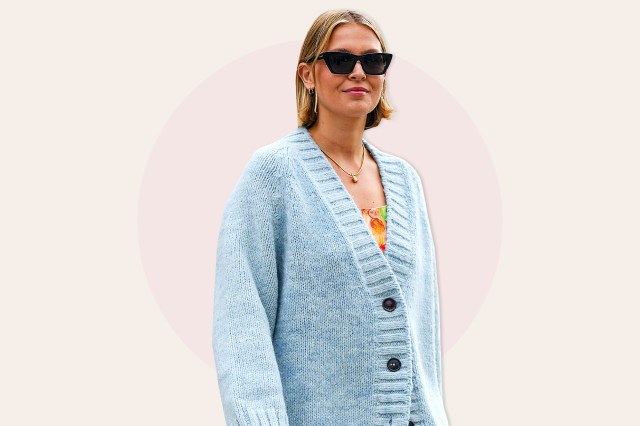 Woman wearing sunglasses, long blue cardigan with buttons