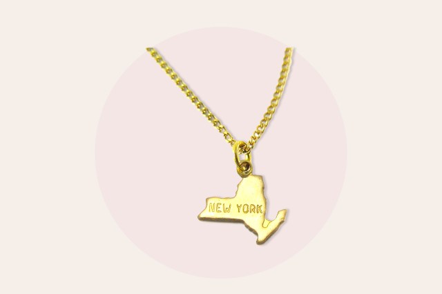 Charm necklace with a New York state shape charm that says "NEW YORK"