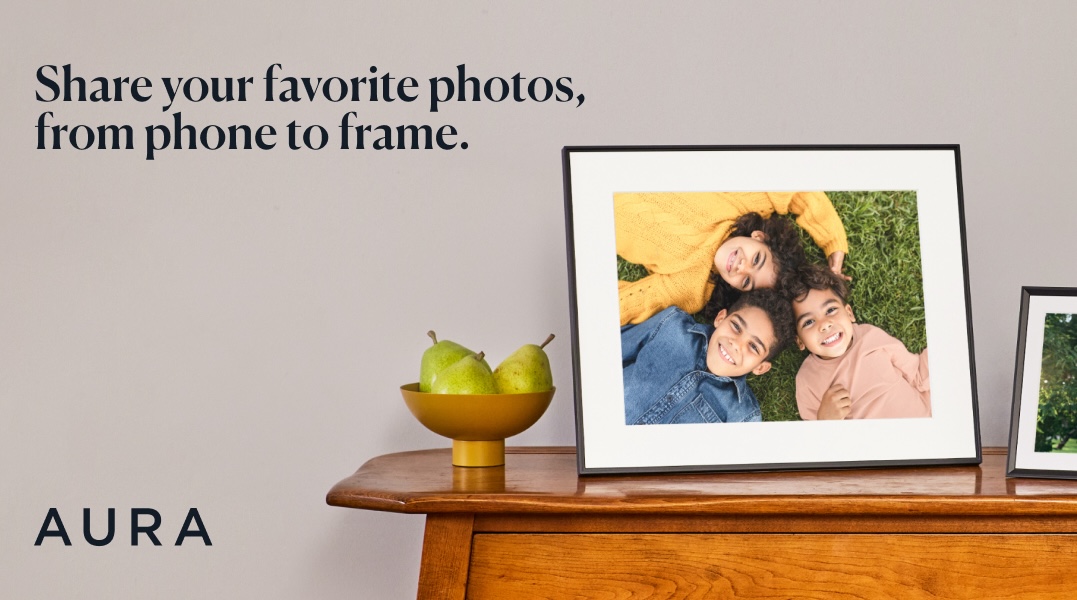 Aura picture frame on table with text that says share your favorite photos, from phone to frame. 