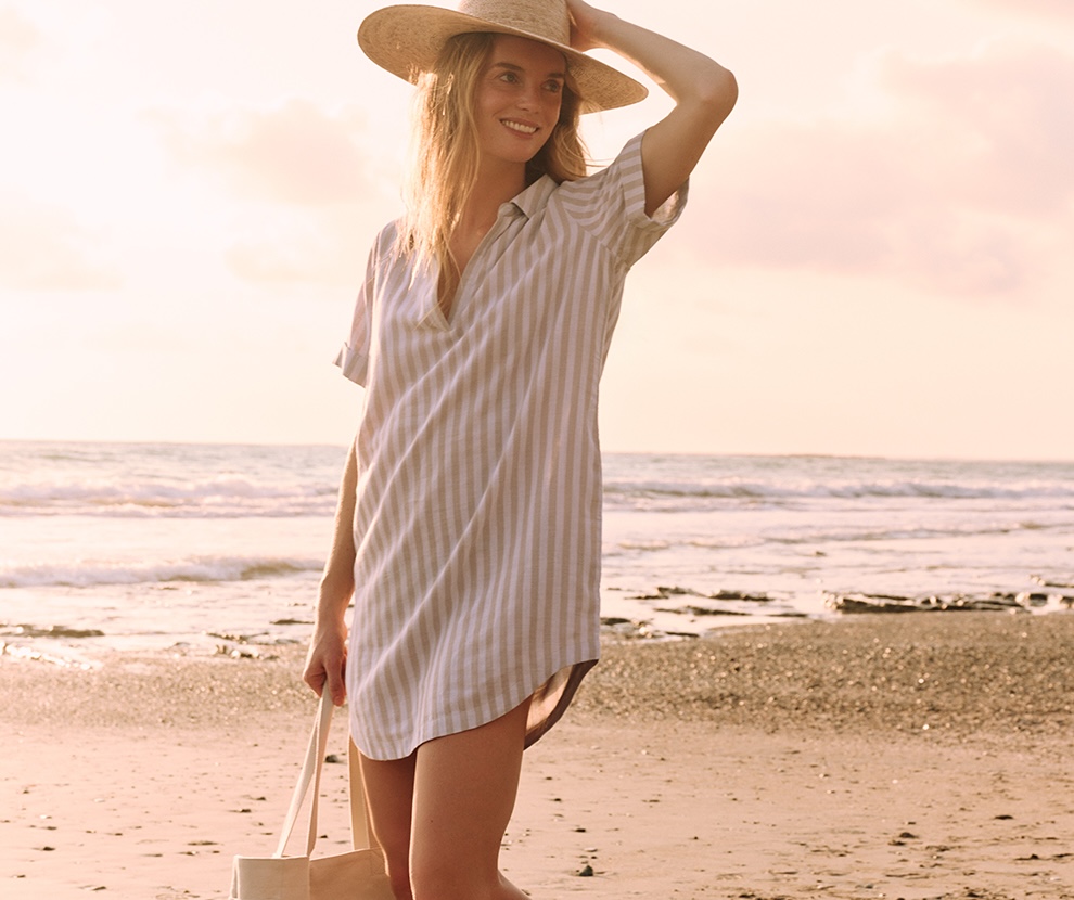 woman on beach in striped tunic