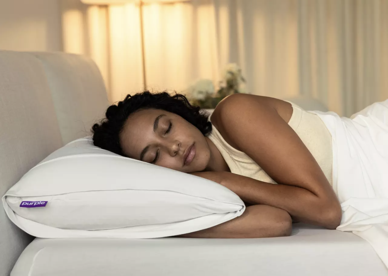 Woman in bed asleep on Purple Harmony pillow