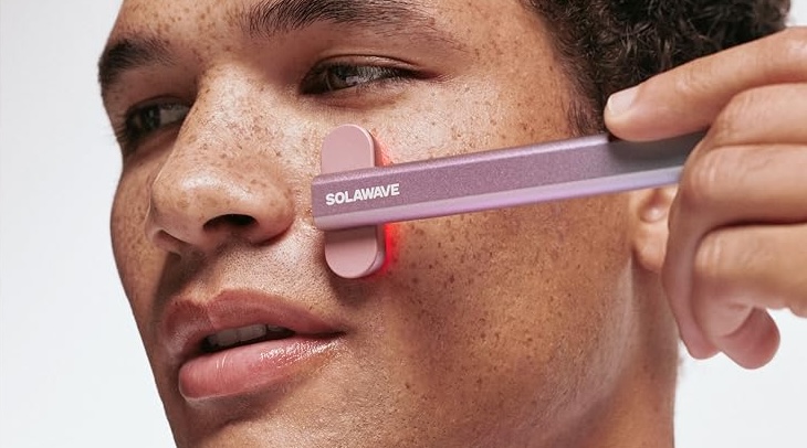 Pink Solwave wand on person's cheek
