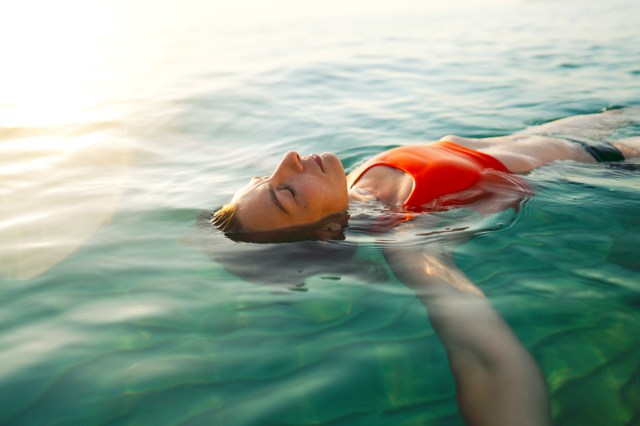 Mid adult woman swimming in the calm sea water