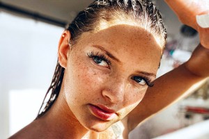 Close up of a freckled women with wet hair