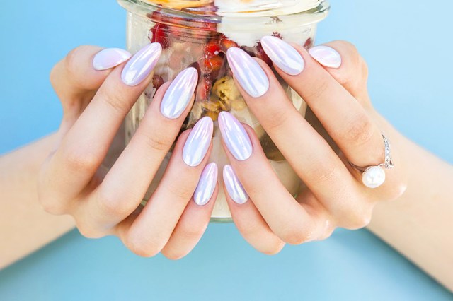 Close up of long, chrome painted nails