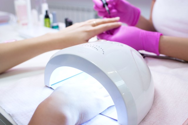 Getting a gel manicure at the nail salon, UV light
