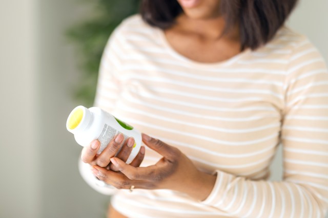 Woman with a bottle of pills in her hands