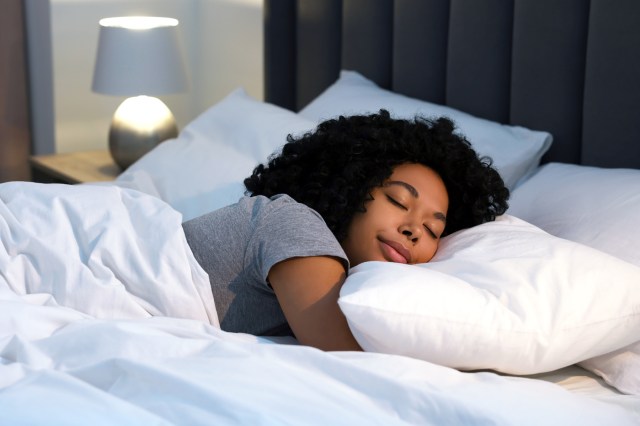 Woman sleeping in bed under the covers