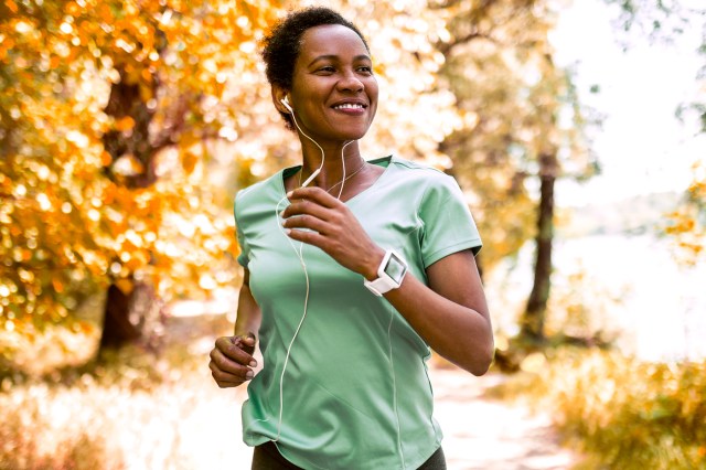 Woman running in the park, smiling