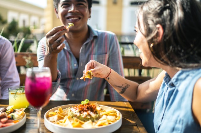 Friends eating guacamole at a restaurant