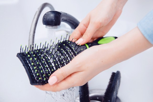 Cleaning a hairbrush in the sink