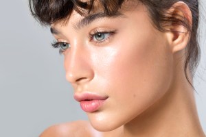Close up studio shot of a beautiful woman with glowy skin