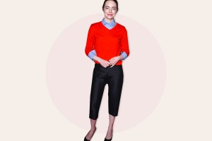 Emma Stone wearing red sweater and black capris