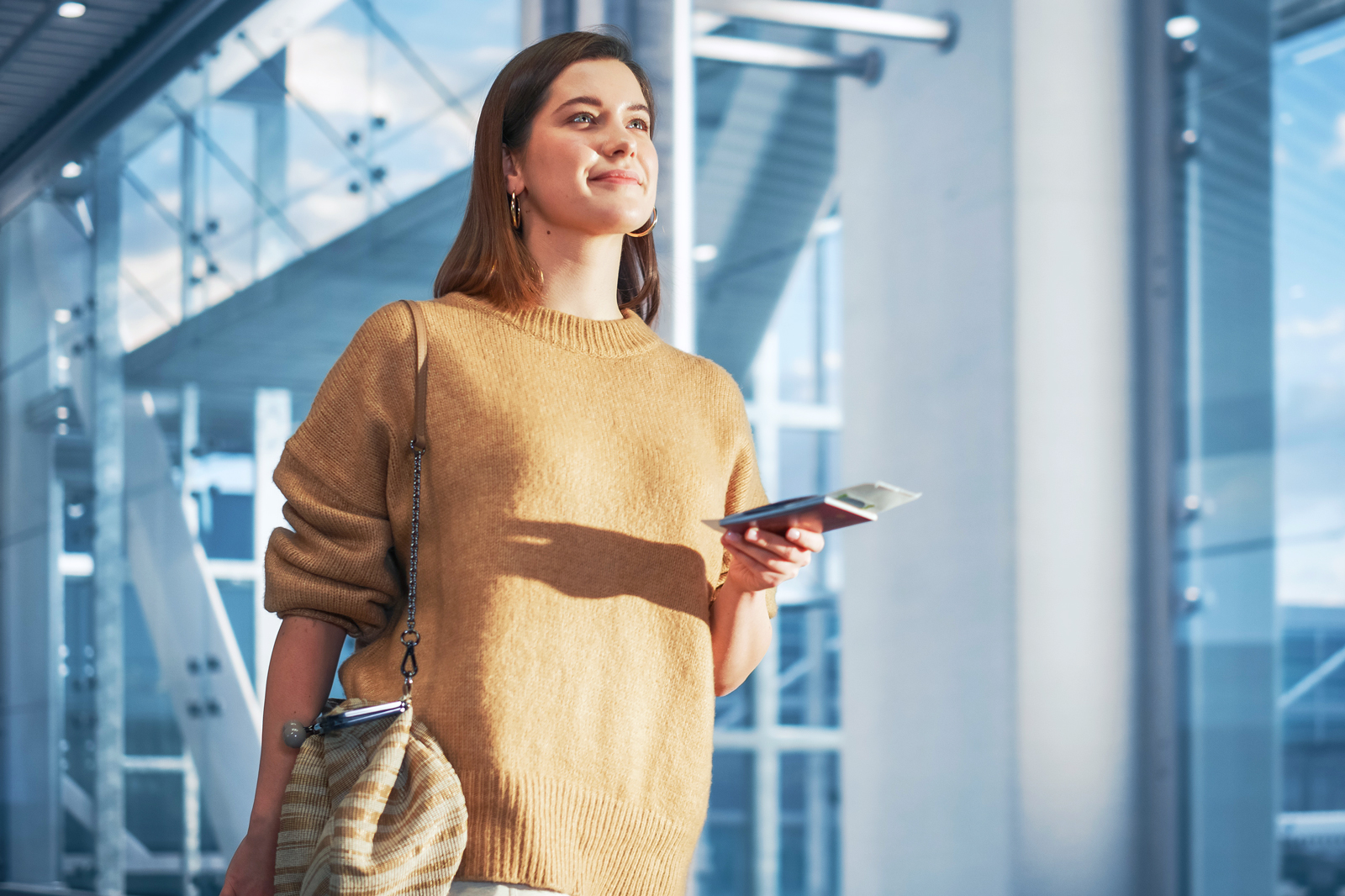 Woman holding airplane ticket in airport