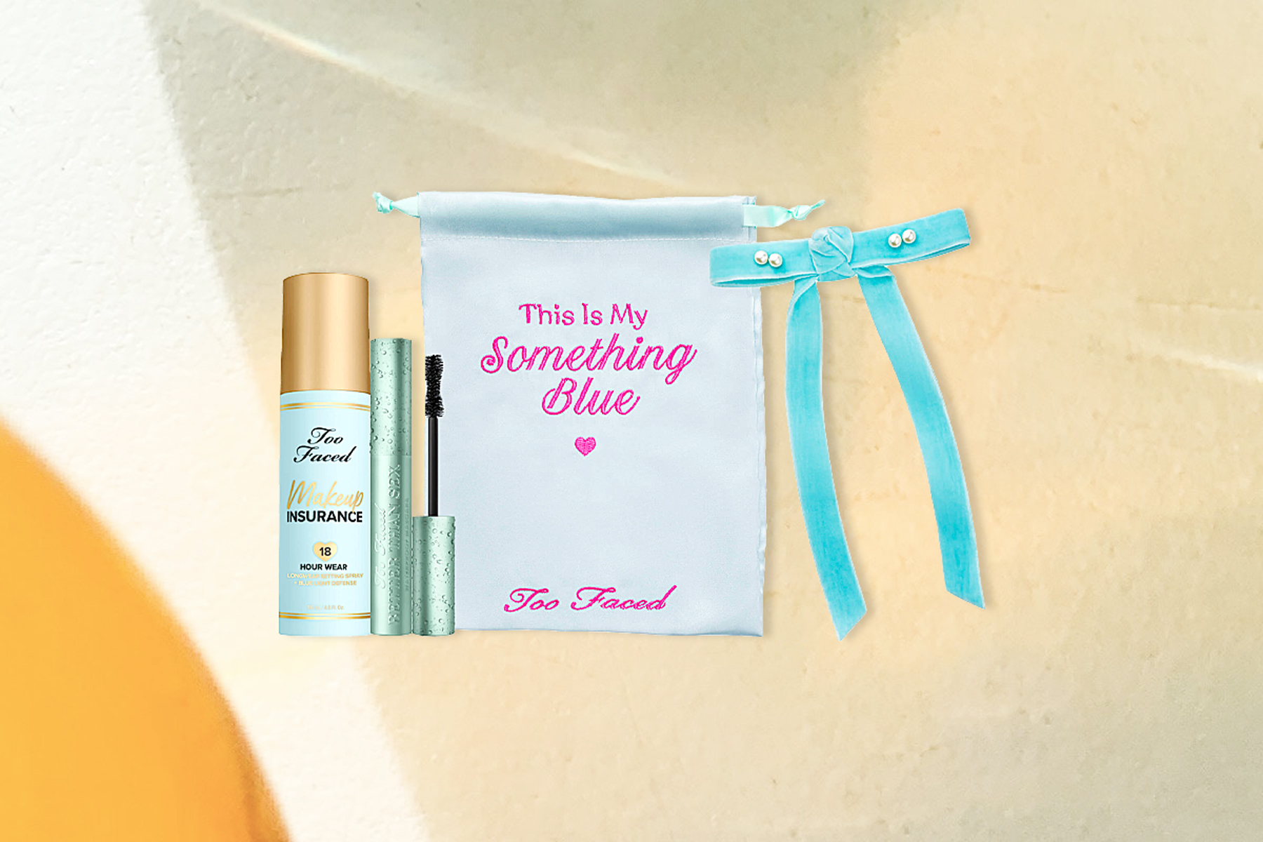 mascara, setting spray, little blue bag and blue bow