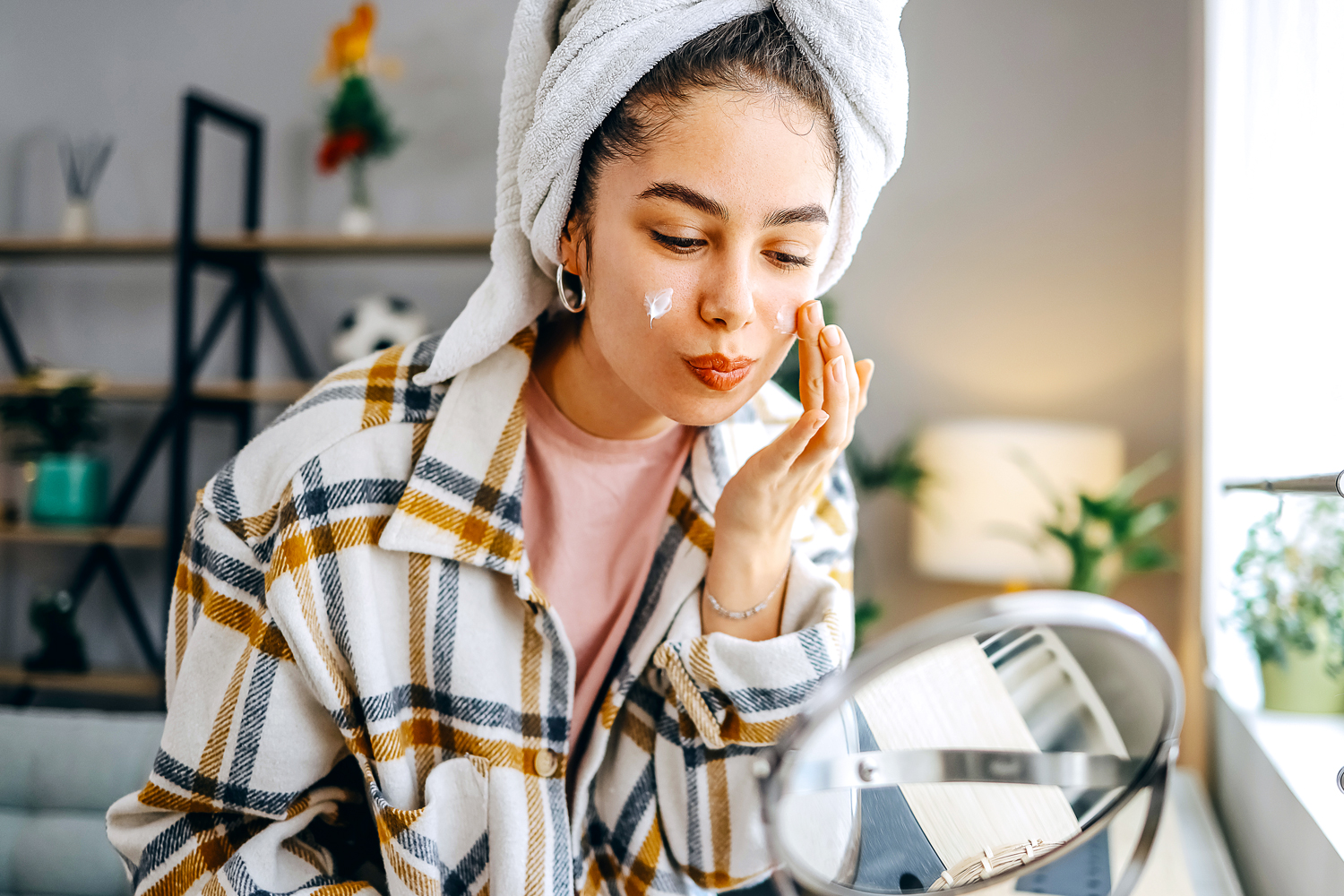 Woman applying face cream