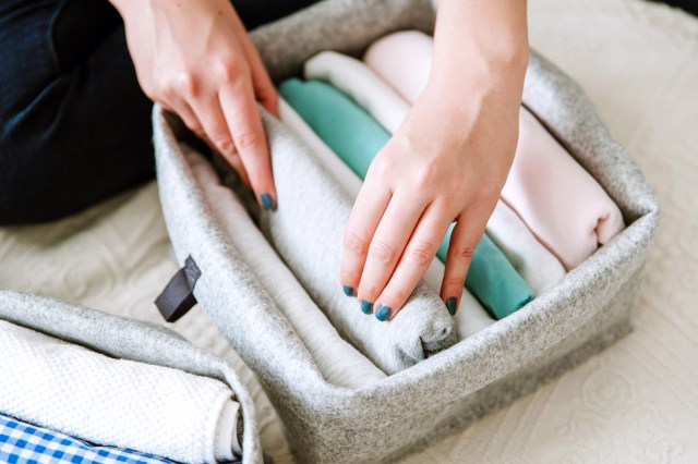 Woman putting clothes away in a clothes organizer