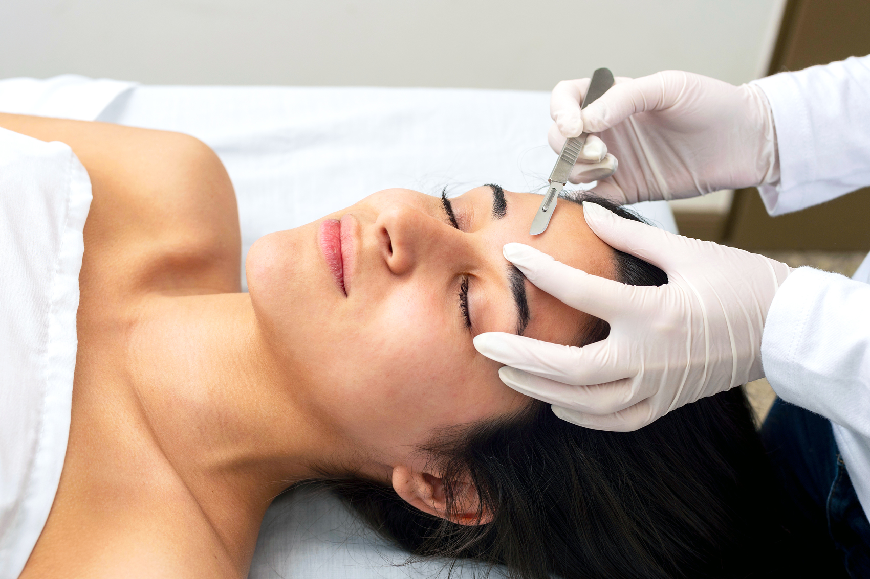 Young woman getting a dermaplaning treatment