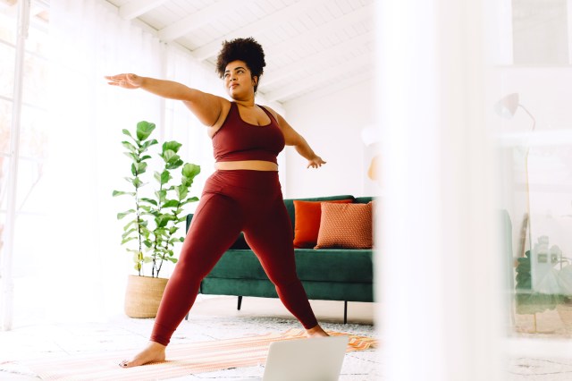 Woman doing yoga in her living room