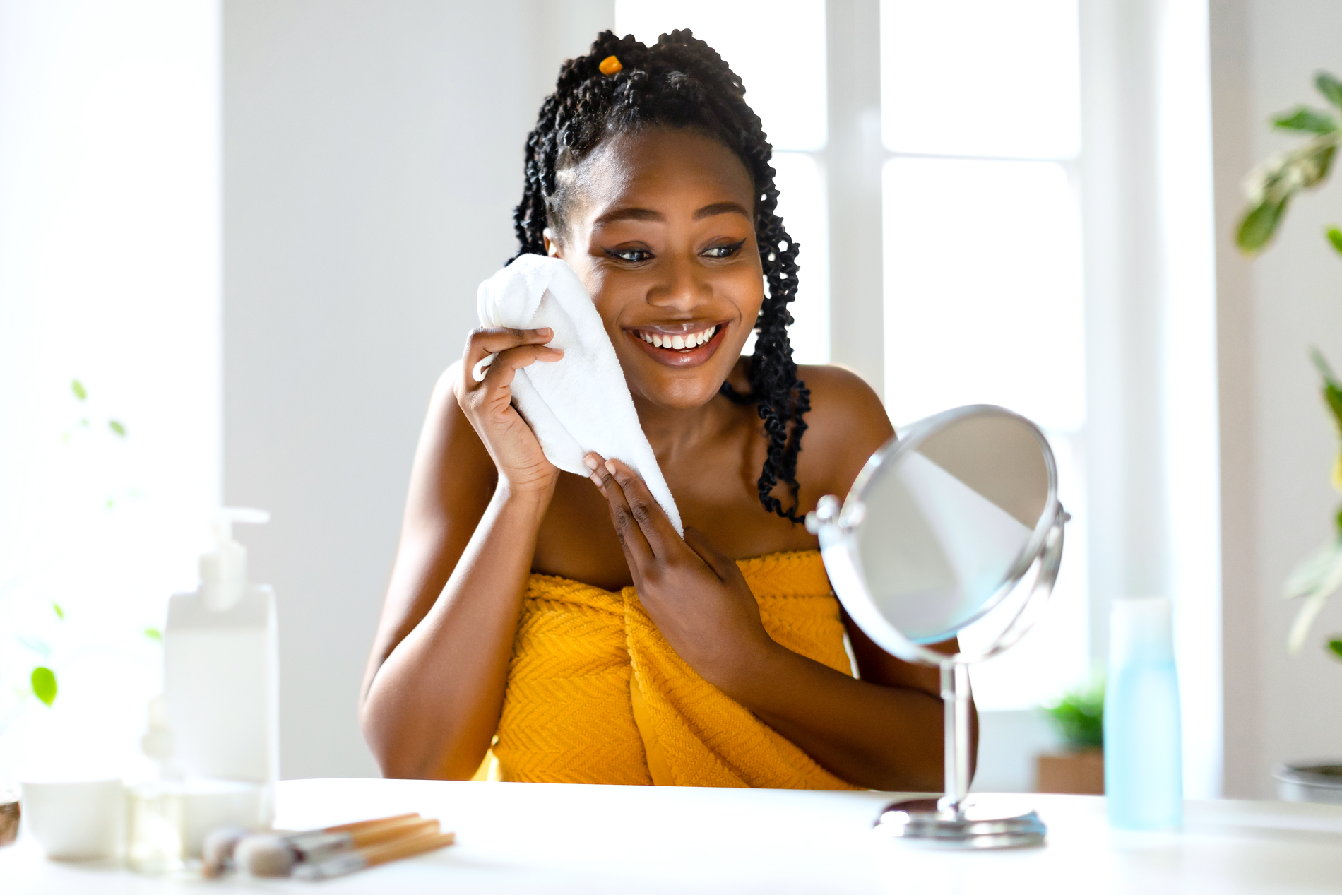 woman washing her face with a washcloth