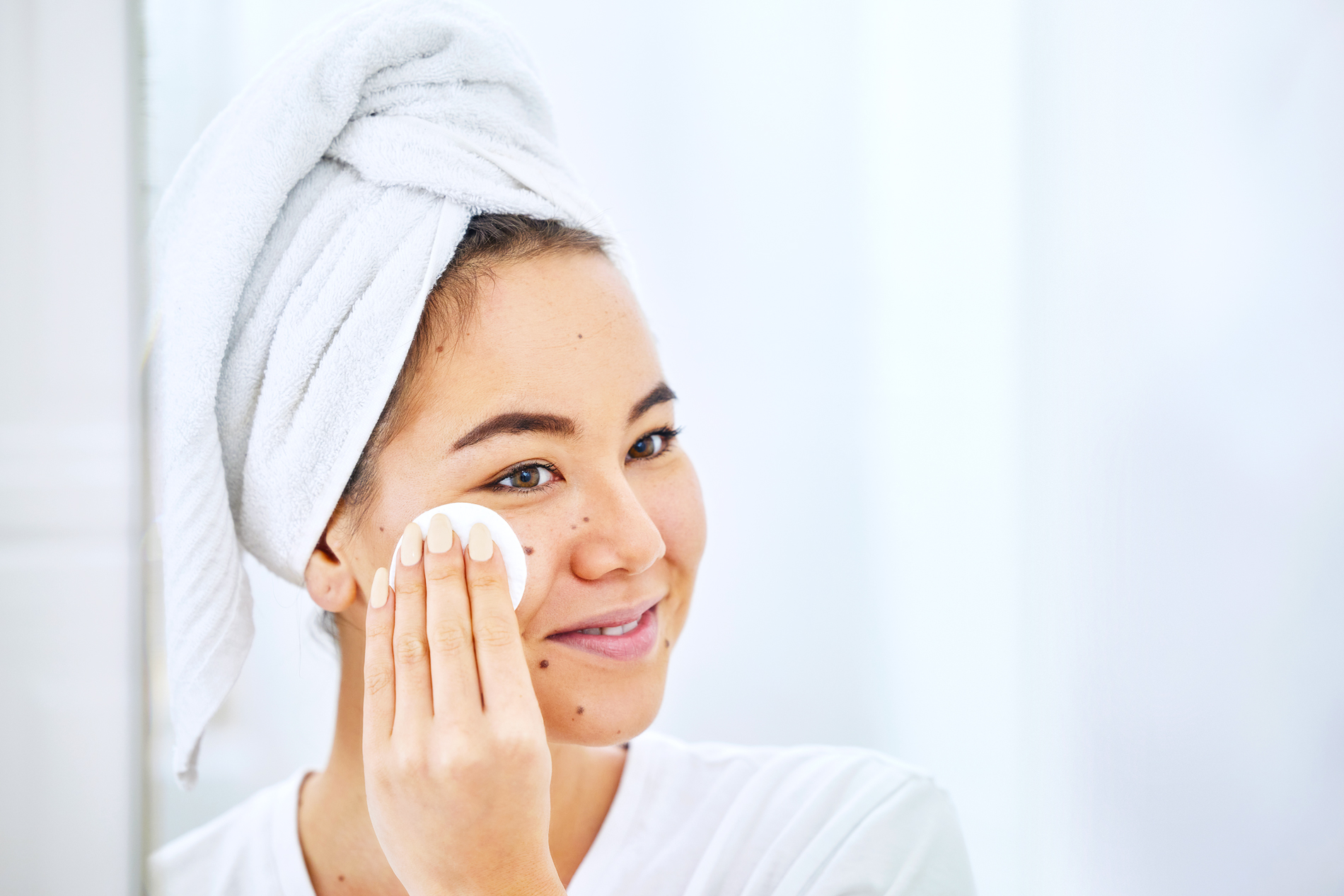 Woman using facial toner