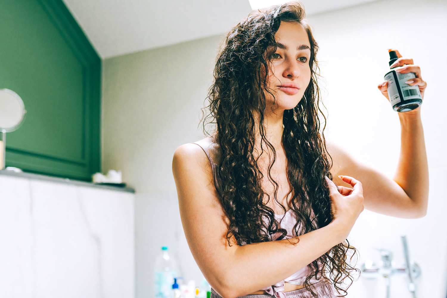 woman spraying her wet hair