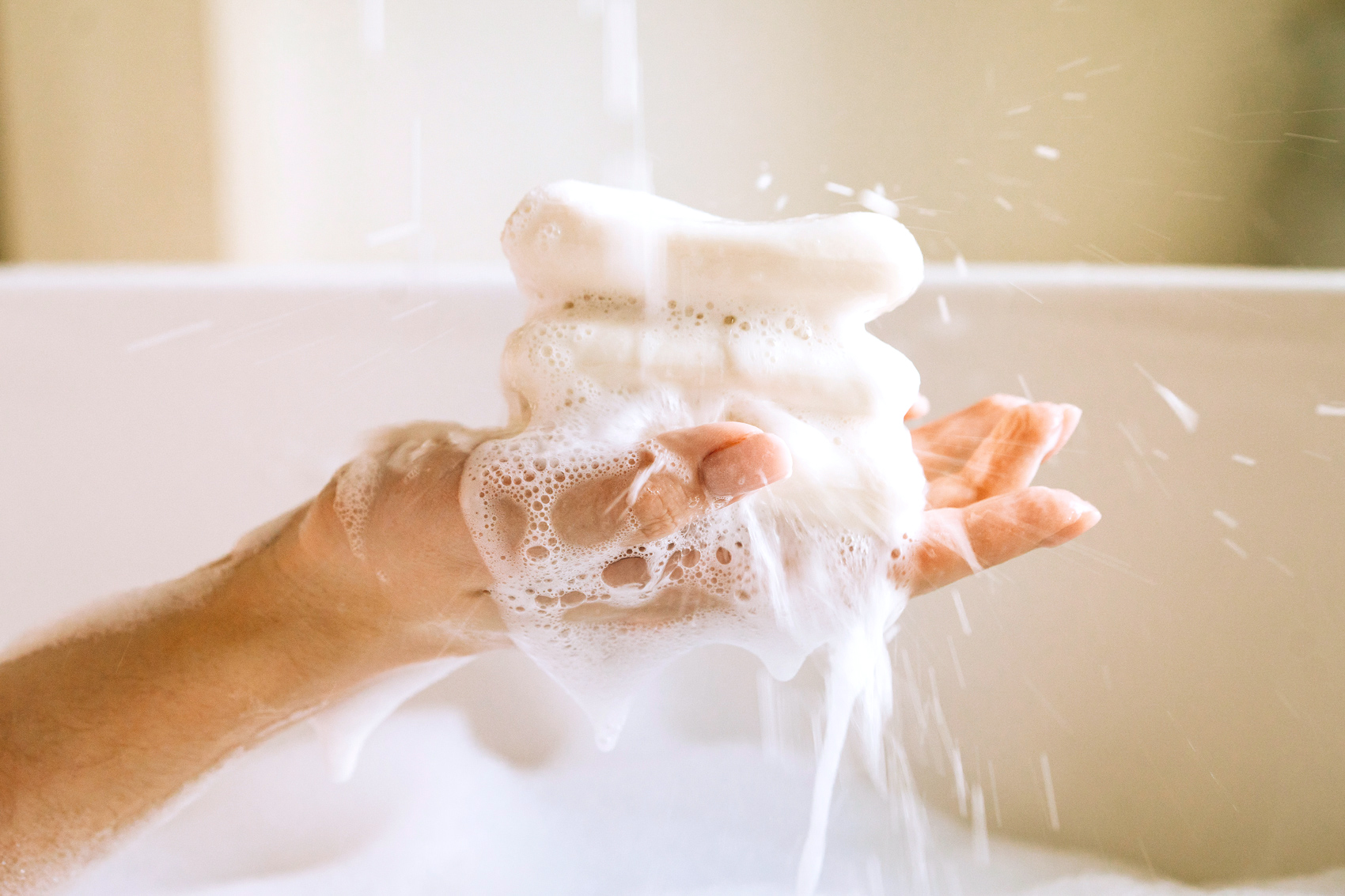 Woman with loofah in a bath