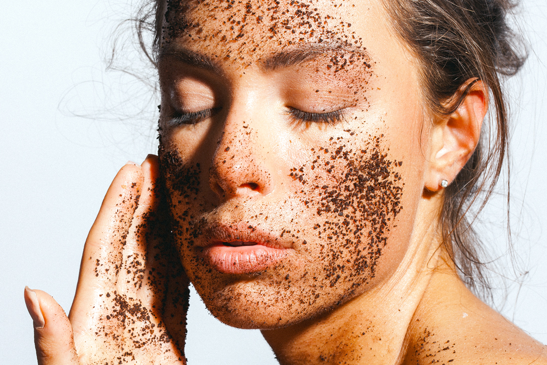 Woman with coffee grounds on her face