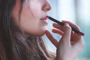 A woman applying lip liner