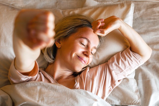 woman stretching in bed