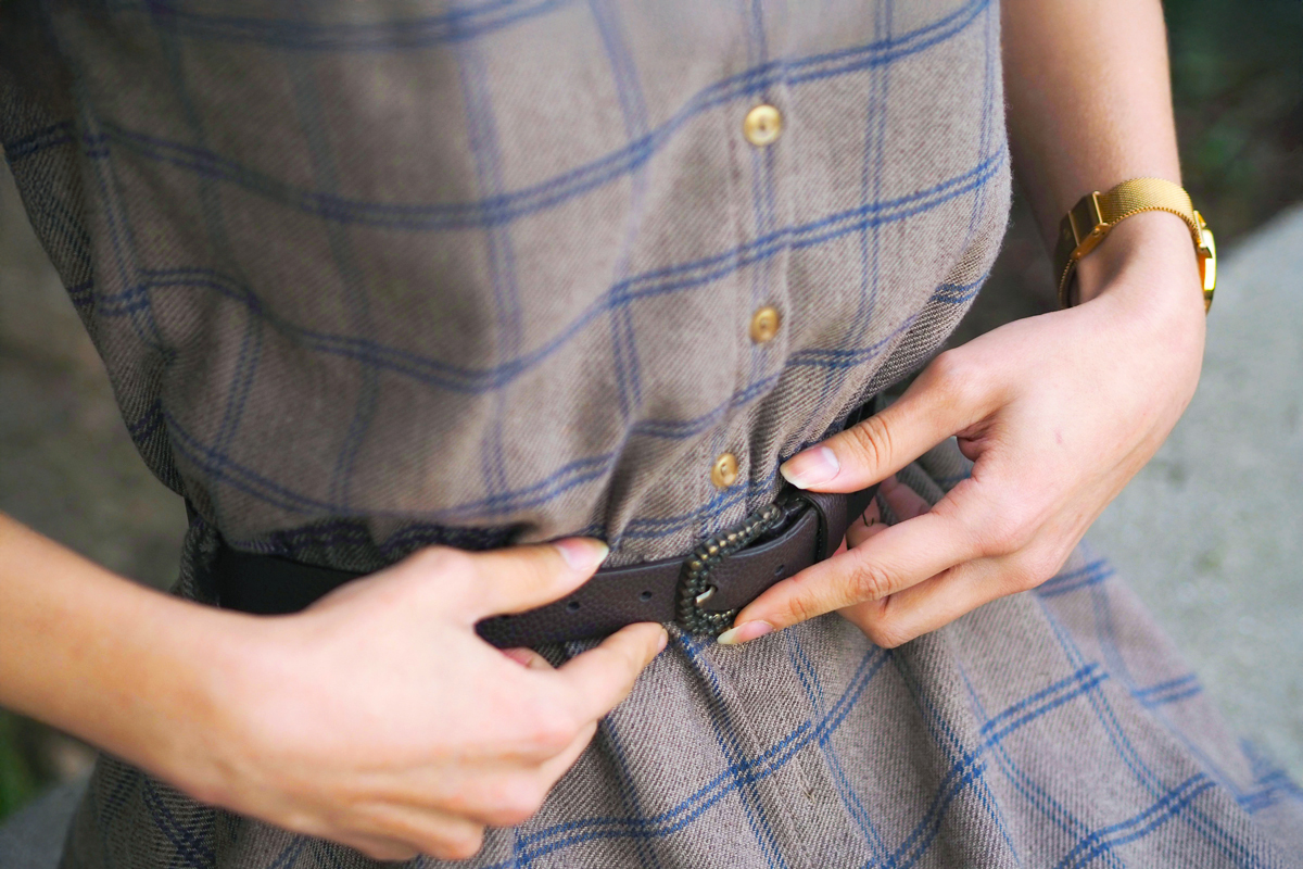 Close up of woman touching her belt