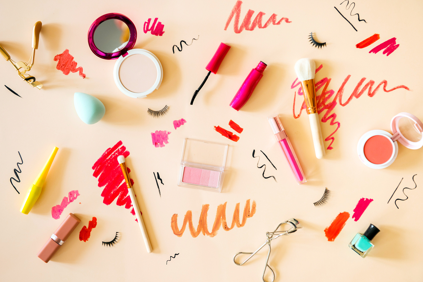 Flat lay of makeup products on beige background