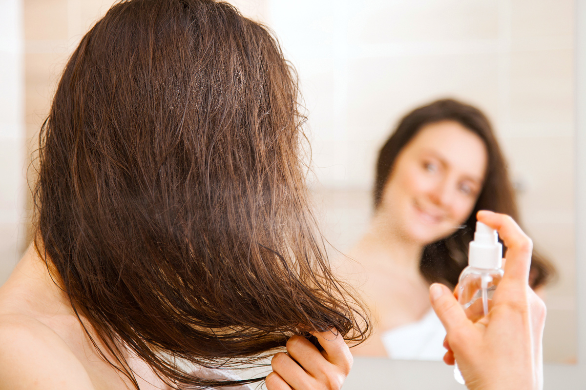 Woman spraying her hair